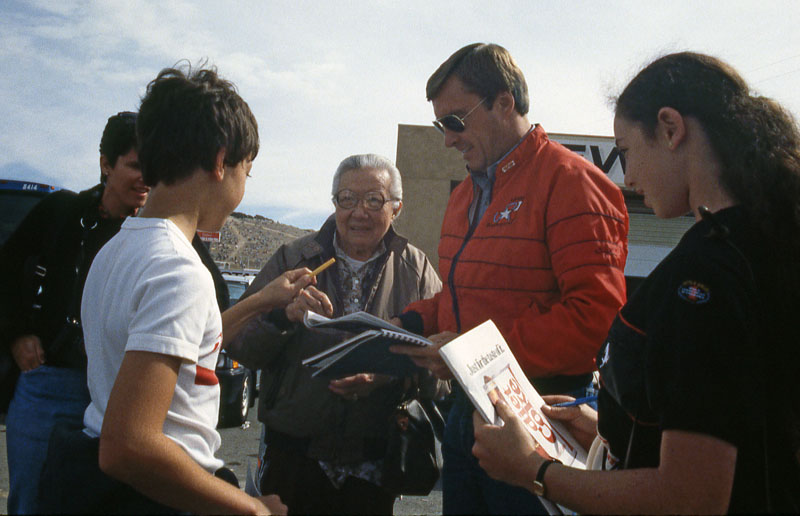 Johnny Rutherford signing autographs